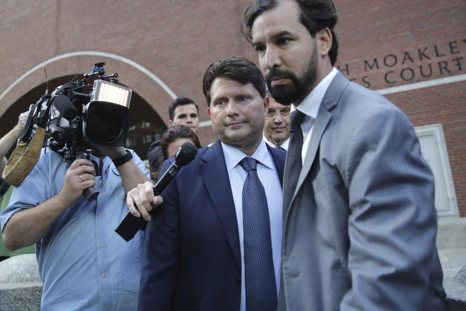 Devin Sloane, center, departs federal court after sentencing in a nationwide college admissions bribery scandal in Boston, Tuesday, Sept. 24, 2019. Sloane admitted to paying $250,000 to get his son into the University of Southern California as a fake athlete. (AP Photo/Charles Krupa)