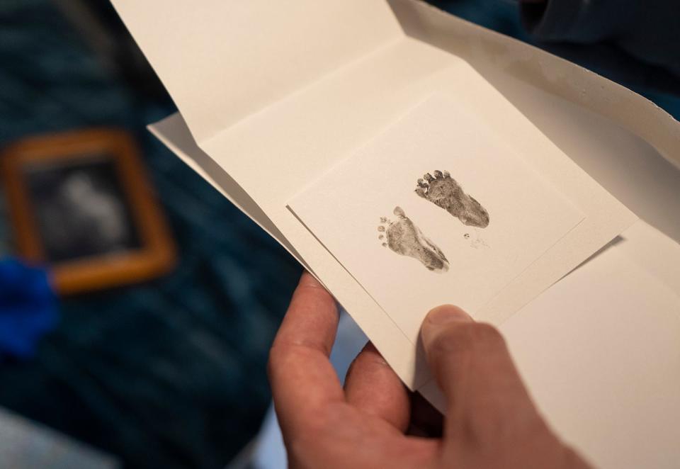 Travis Edwards looks at his first baby's footprints in the family's home. The prints were made by staffers at the abortion clinic in Colorado where Phoebe lived her last moments.