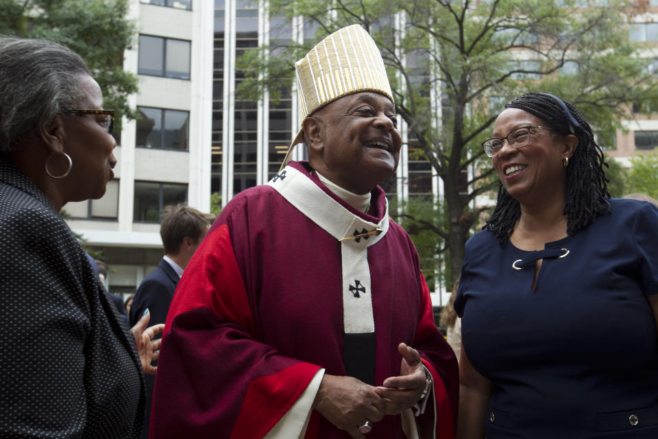 FILE - In this Sunday Oct. 6, 2019, file photo, Washington D.C. Archbishop Wilton Gregory greets churchgoers at St. Mathews Cathedral after the annual Red Mass in Washington. Pope Francis on Sunday, Oct. 25, 2020, named 13 new cardinals, including Washington D.C. Archbishop Wilton Gregory, who would become the first Black U.S. prelate to earn the coveted red hat. In a surprise announcement from his studio window to faithful standing below in St. Peter’s Square, Francis said the churchmen would be elevated to a cardinal’s rank in a ceremony on Nov. 28. (AP Photo/Jose Luis Magana, File)