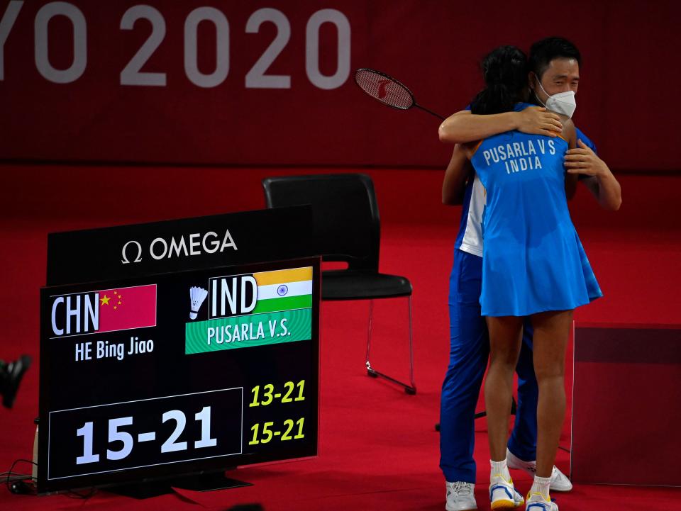 India's P. V. Sindhu celebrates with a coach after beating China's He Bingjiao in their women's singles badminton bronze medal match during the Tokyo 2020 Olympic Games at the Musashino Forest Sports Plaza in Tokyo on August 1, 2021. (Photo by Alexander NEMENOV / AFP) (Photo by ALEXANDER NEMENOV/AFP via Getty Images)