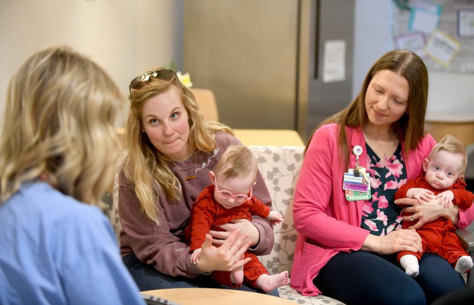 Nurse Carey-ann Phillips, left, a lactation consultant, visits with new mom Haley Hake, center, and Dr. Arielle Bokisa at Aultman Hospital in Canton.