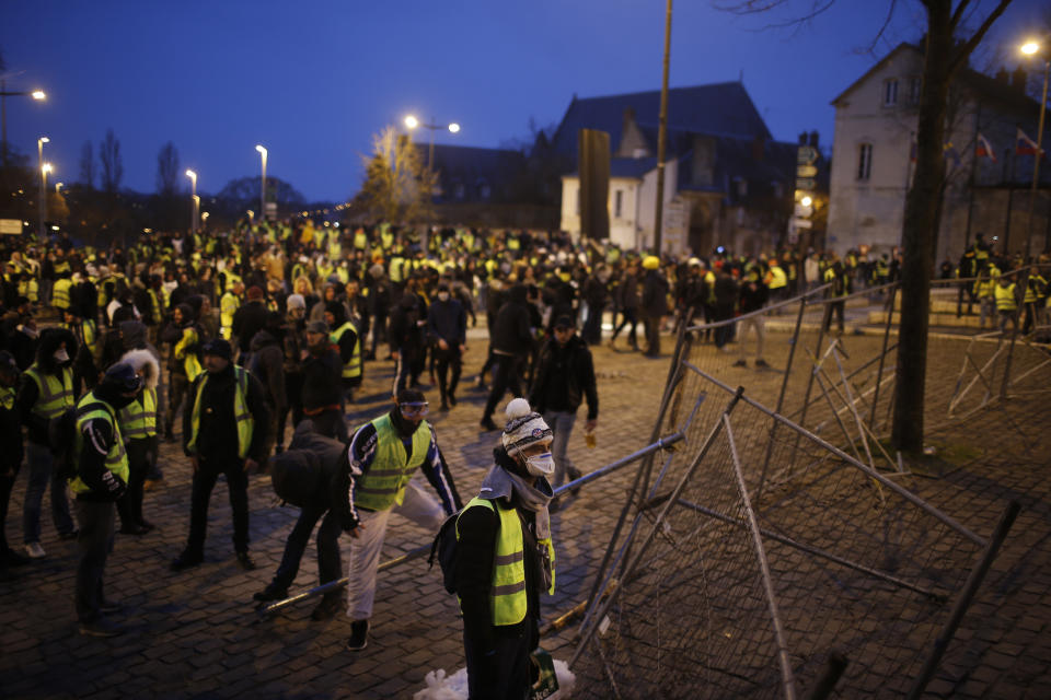 Yellow vest protestors arm themselves with metal bars during a demonstration in Bourges, central France, Saturday, Jan. 12, 2019. Paris brought in armored vehicles and the central French city of Bourges shuttered shops to brace for new yellow vest protests. The movement is seeking new arenas and new momentum for its weekly demonstrations. Authorities deployed 80,000 security forces nationwide for a ninth straight weekend of anti-government protests. (AP Photo/Rafael Yaghobzadeh)