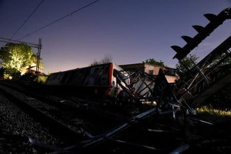 A derailed train carriage is seen toppled in the town of Adendro in northern Greece, May 14, 2017. REUTERS/Alexandros Avramidis