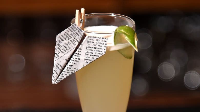 cocktail with paper plane garnish