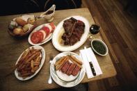 <strong>The Reviewer: </strong>Pete Wells, <em>The New York Times</em><strong> Choice Cuts: </strong>Wells has not always hated the well-known steakhouse. At the start of his <a href="https://www.nytimes.com/2019/10/29/dining/peter-luger-review-pete-wells.html" rel="nofollow noopener" target="_blank" data-ylk="slk:brutal zero-star review;elm:context_link;itc:0;sec:content-canvas" class="link ">brutal zero-star review</a>, he recalls happily emptying out his wallet to eat one of their sizzling porterhouse or rib steaks in the 1990s. “Because a Peter Luger steak made me feel alive in a way that few other things did, I considered this a fair trade.” But a visit back in October 2019, did not encourage the same exchange. He likens the shrimp cocktail to “cold latex dipped in ketchup and horseradish,” calls the dole “dry and almost powder,” and the Caesar salad “drippy” with croutons straight out of the bag. “I know there was a time the German fried potatoes were brown and crunchy, because I eagerly ate them each time I went,” he writes. “Now they are mushy, dingy, gray and sometimes cold. I look forward to them the way I look forward to finding a new, irregularly shaped mole.” His porterhouse was equally disappointing. Though he "could live" with its ranging degree of doneness despite his request for medium-rare, Wells still called the meat “far from the best New York has to offer.” <strong>The Pièce de Résistance: </strong>“There is almost always a wait, with or without a reservation, and there is almost always a long line of supplicants against the wall. A kind word or reassuring smile from somebody on staff would help the time pass. The smile never comes. The Department of Motor Vehicles is a block party compared with the line at Peter Luger.”