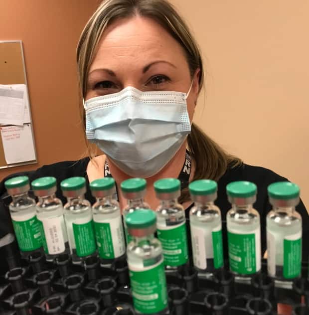 A nurse at the vaccine clinic for first responders on Mundy Pond Road in St. John's shows off vials of the AstraZeneca-Oxford COVID-19 vaccine. (Terry Roberts/CBC - image credit)