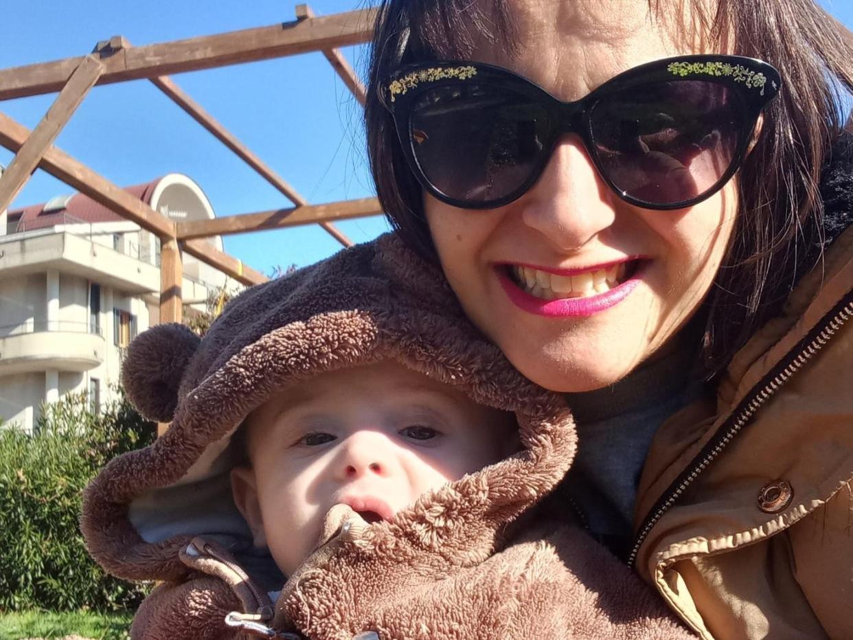 Caroline Chirichella and her son Nicola. She is wearing sunglasses and they are smiling outside.