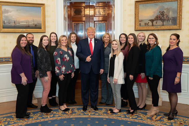 <p>Alamy</p> Amber and Steve Lemke (left) and the SFA women's bowling team meet former President Donald Trump