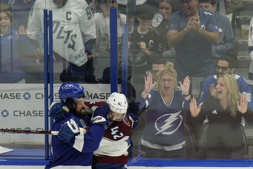 Tampa Bay Lightning left wing Pat Maroon (14) and Colorado Avalanche defenseman Josh Manson (42) scuffle during the second period of Game 3 of the NHL hockey Stanley Cup Final on Monday, June 20, 2022, in Tampa, Fla. (AP Photo/Chris O'Meara)