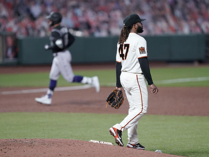 San Francisco Giants starting pitcher Johnny Cueto (47) stands on the mound as Colorado Rockies' Kevin Pillar, left, rounds the bases after hitting a solo home run during the third inning of a baseball game on Monday, Sept. 21, 2020, in San Francisco. (AP Photo/Tony Avelar)