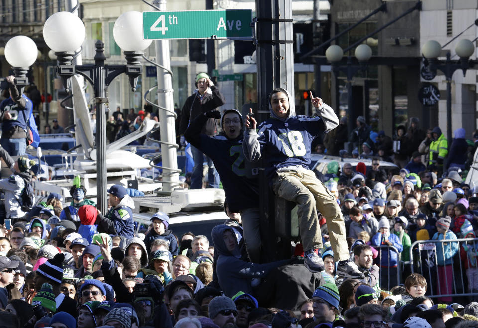 Seattle Seahawks fans cheer during the Super Bowl champions parade on Wednesday, Feb. 5, 2014, in Seattle. The Seahawks beat the Denver Broncos 43-8 in NFL football's Super Bowl XLVIII on Sunday. (AP Photo/Ted S. Warren)