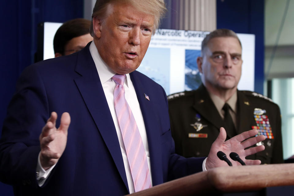 President Donald Trump speaks about the coronavirus in the James Brady Press Briefing Room of the White House, Wednesday, April 1, 2020, in Washington, as Chairman of the Joint Chiefs General Mark Milley, listens. / Credit: Alex Brandon / AP