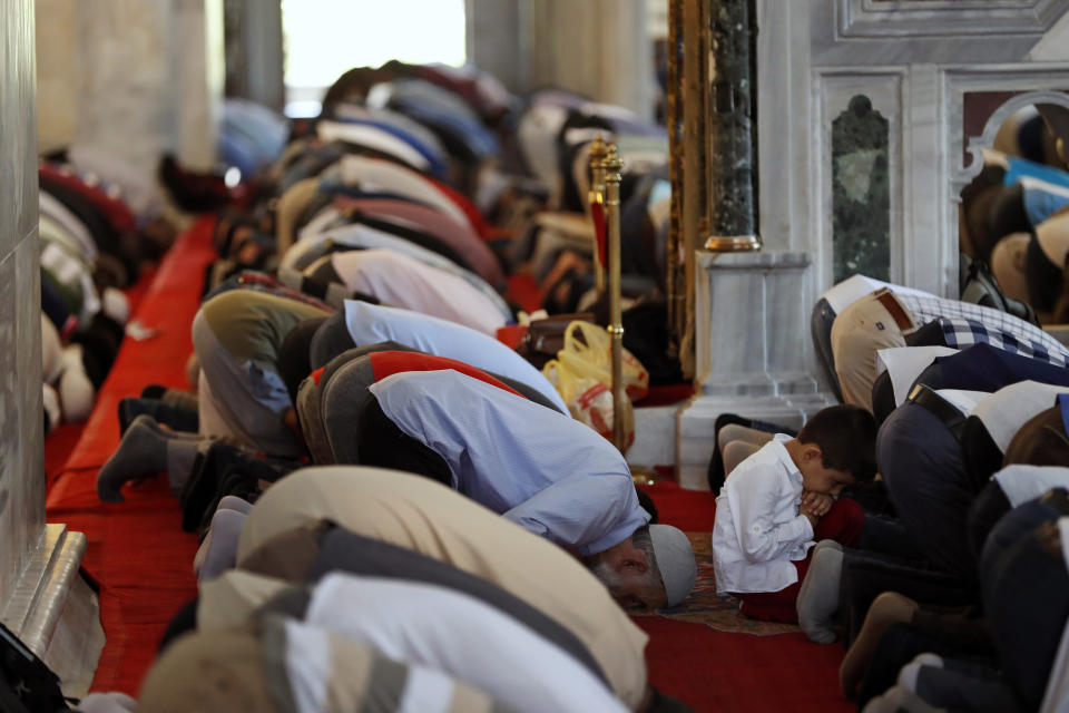 In this photo taken on Tuesday, Aug. 20, 2019, a Syrian boy prays at Fatih mosque in Istanbul. Syrians say Turkey has been detaining and forcing some Syrian refugees to return back to their country the past month. The expulsions reflect increasing anti-refugee sentiment in Turkey, which opened its doors to millions of Syrians fleeing their country's civil war. (AP Photo/Lefteris Pitarakis)