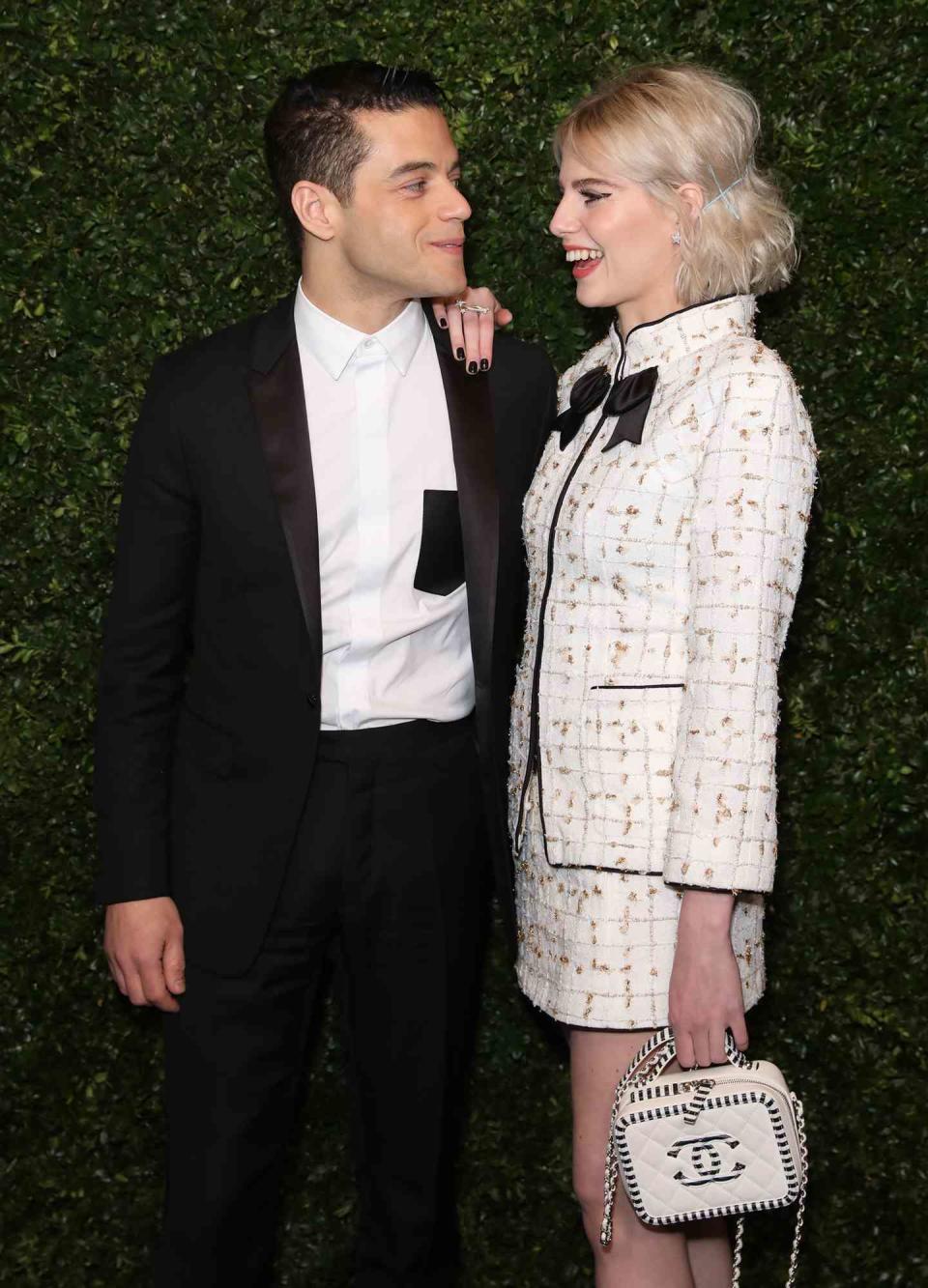 Lucy Boynton and Rami Malek arrive for the Charles Finch x Chanel pre-Bafta dinner, in Mayfair, London