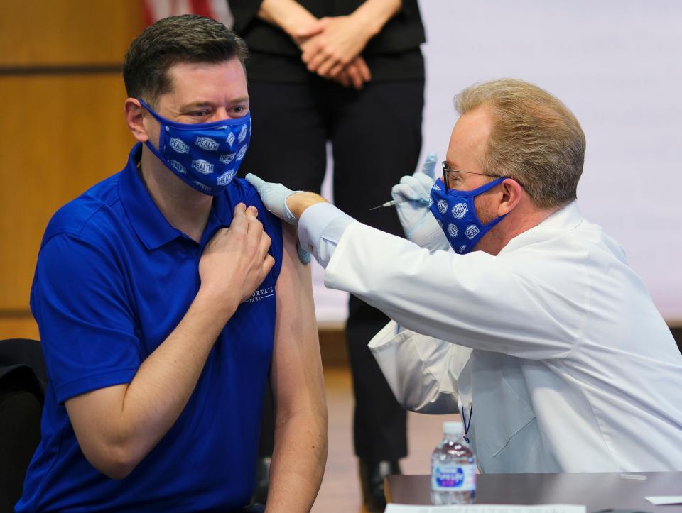 Oklahoma City Mayor David Holt receives his first dose of Pfizer's COVID-19 vaccine from Oklahoma City-County Health Department Director Dr. Patrick McGough on Monday.