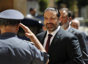 Lebanese Prime Minister Said Hariri arrives at the parliament building, where lawmakers are meeting for the opening session on the draft 2019 state budget, in Beirut, Lebanon, Tuesday, July 16, 2019. Lebanese lawmakers have begun discussing the budget amid tight security and limited protests against proposed austerity measures. The proposed budget aims to avert a financial crisis by raising taxes and cutting public spending in an effort to reduce a ballooning deficit. (AP Photo/Hussein Malla)