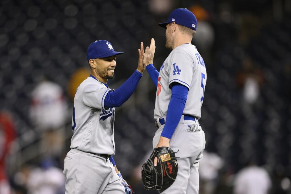 Dodgers' Mookie Betts celebrates with Freddie Freeman after defeating the Washington Nationals.