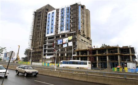 Traffic passes along a street with buildings under construction in Ethiopia's capital Addis Ababa, September 15, 2013. REUTERS/Tiksa Negeri
