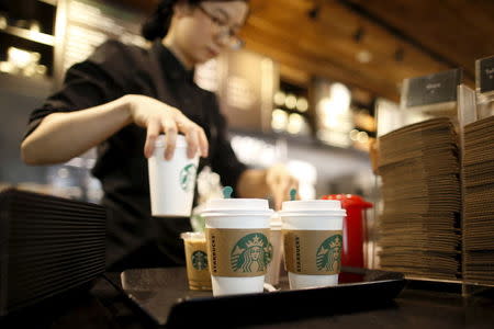 A staff serves beverages at a Starbucks coffee shop in Seoul, South Korea, March 7, 2016. Picture taken March 7, 2016. REUTERS/Kim Hong-Ji