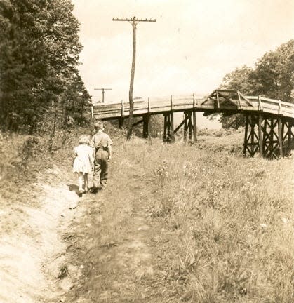 Dale Roberts and his sister, Margaret, walk along Springdale Avenue in Oakley toward the Sayles Biltmore Bleachery bridge, since replaced.