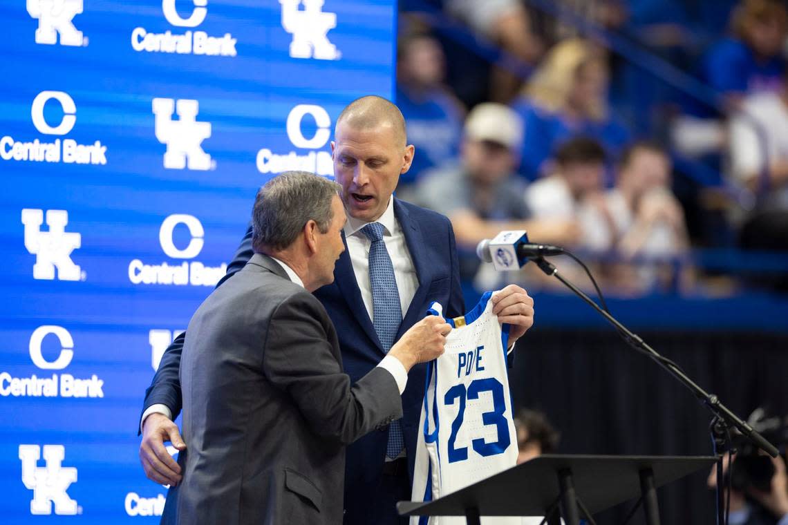 UK athletics director Mitch Barnhart gives Mark Pope a Kentucky basketball jersey with No. 23 at his press conference. Pope is the 23rd coach in program history and the seventh since Adolph Rupp retired in 1972.