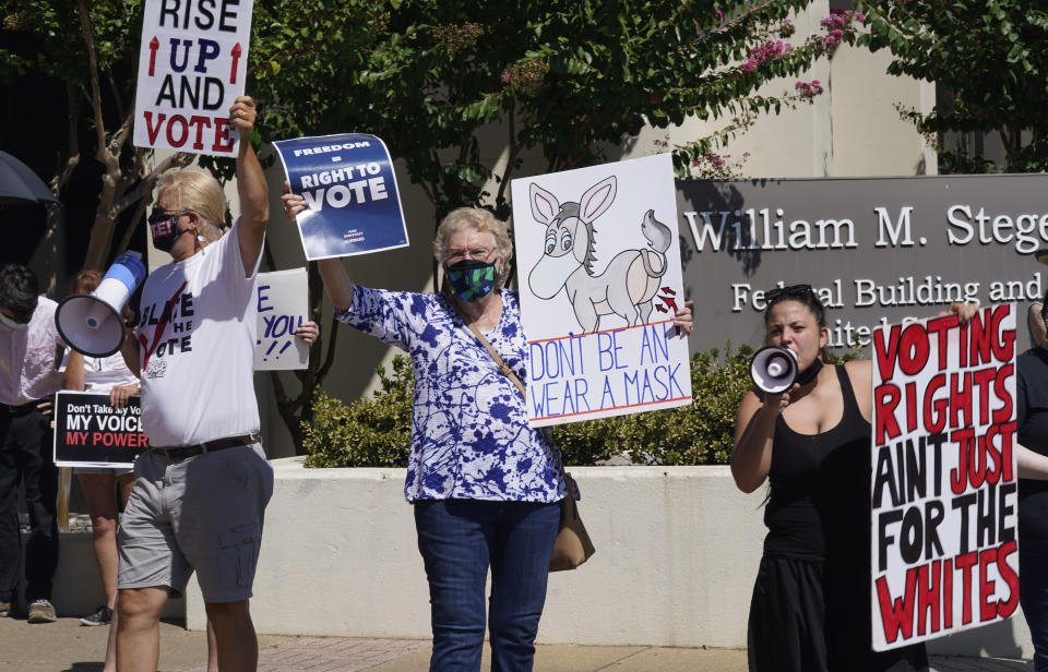 Protesters gather outside where Texas Gov Greg Abbott signed Senate Bill 1, also known as the election integrity bill, into law in Tyler, Texas, Tuesday, Sept. 7, 2021. The sweeping bill signed Tuesday by the two-term Republican governor further tightens Texas’ strict voting laws.(AP Photo/LM Otero)