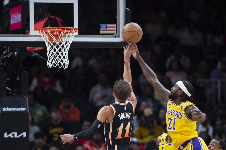 Atlanta Hawks guard Trae Young shoots against Los Angeles Lakers guard Patrick Beverley during the first half of an NBA basketball game Friday, Dec. 30, 2022, in Atlanta. (AP Photo/Hakim Wright Sr.)