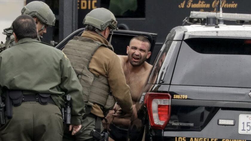 L.A. County sheriff's deputies escort Isaias De Jesus Valencia, suspected of fatally shooting a Pomona police officer.