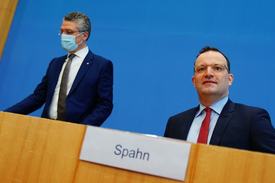 Lothar Wieler, left, president of the Robert Koch Institute (RKI), and German Health Minister Jens Spahn, right, arrive for a press conference in Berlin, Germany, Friday, March 5, 2021. Wieler, the head of Germany’s disease control agency, is urging people to get vaccinated for the coronavirus when given the opportunity, no matter which vaccine is offered. (Michael Kappeler/DPA via AP, Pool)