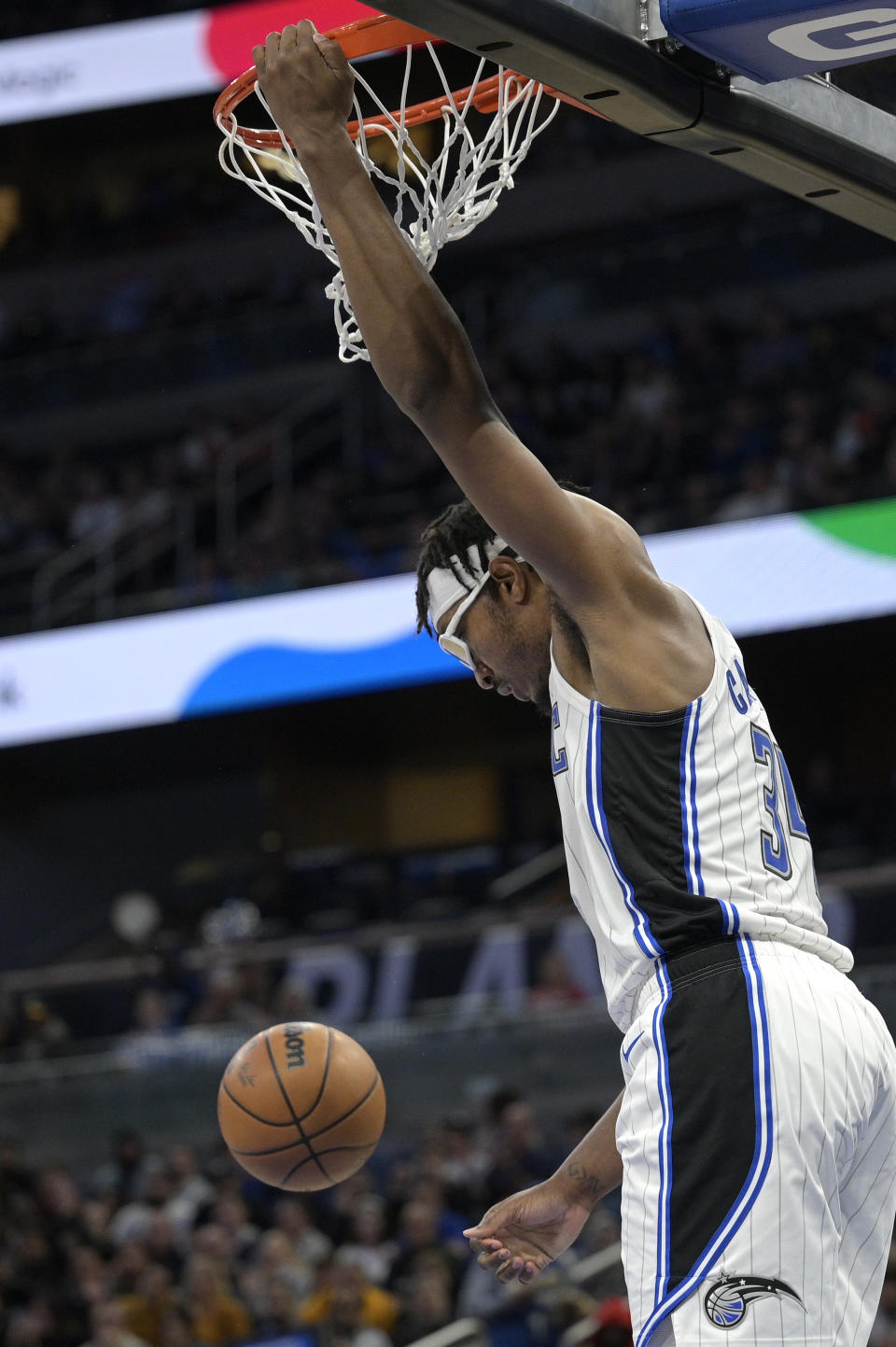 Orlando Magic center Wendell Carter Jr. (34) hangs on the rim after dunking during the first half of an NBA basketball game against the Dallas Mavericks, Wednesday, Nov. 9, 2022, in Orlando, Fla. (AP Photo/Phelan M. Ebenhack)