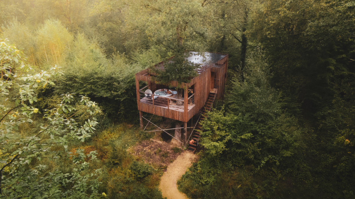  An aerial shot of a suite at Loire Valley Lodges, showing a couple in a Jacuzzi hot tub. 