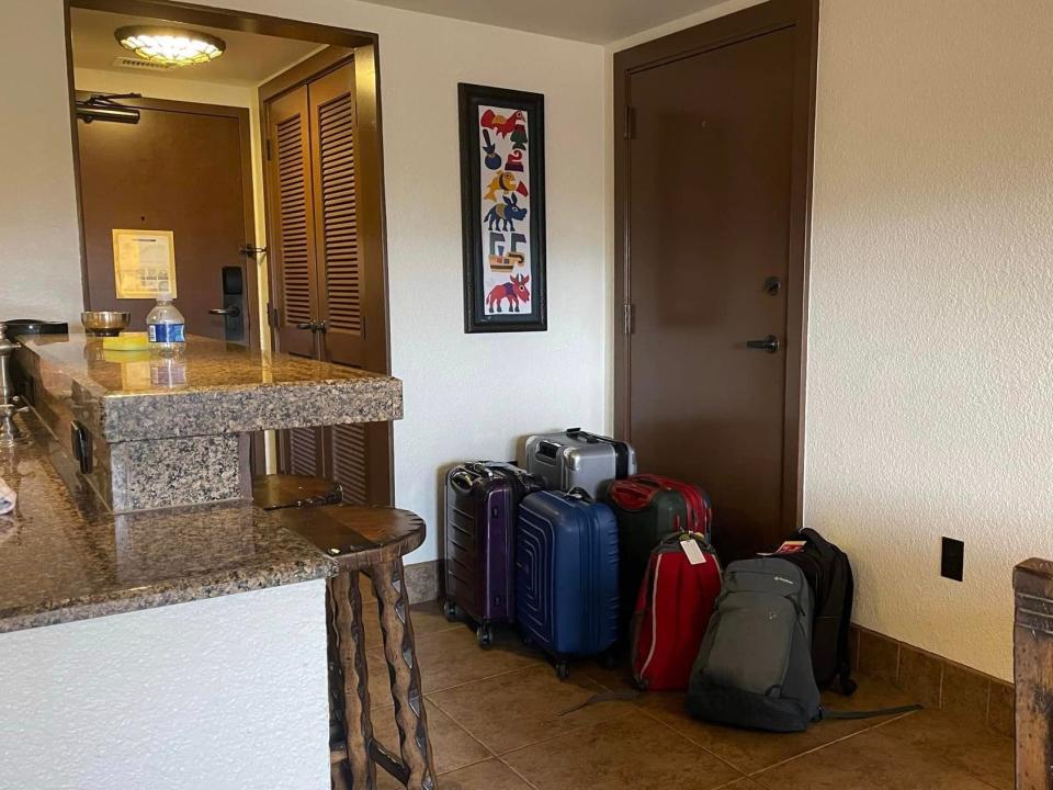 jills family's bags piled by the door at a villa in disney world