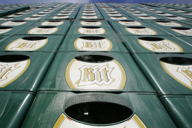 Bitburger crates are piled up on the brewery premises. Strong business in pubs and restaurants helped Germany's Bitburger Brewery record increased turnover in 2023 despite a drop in overall sales. Fredrik von Erichsen/dpa