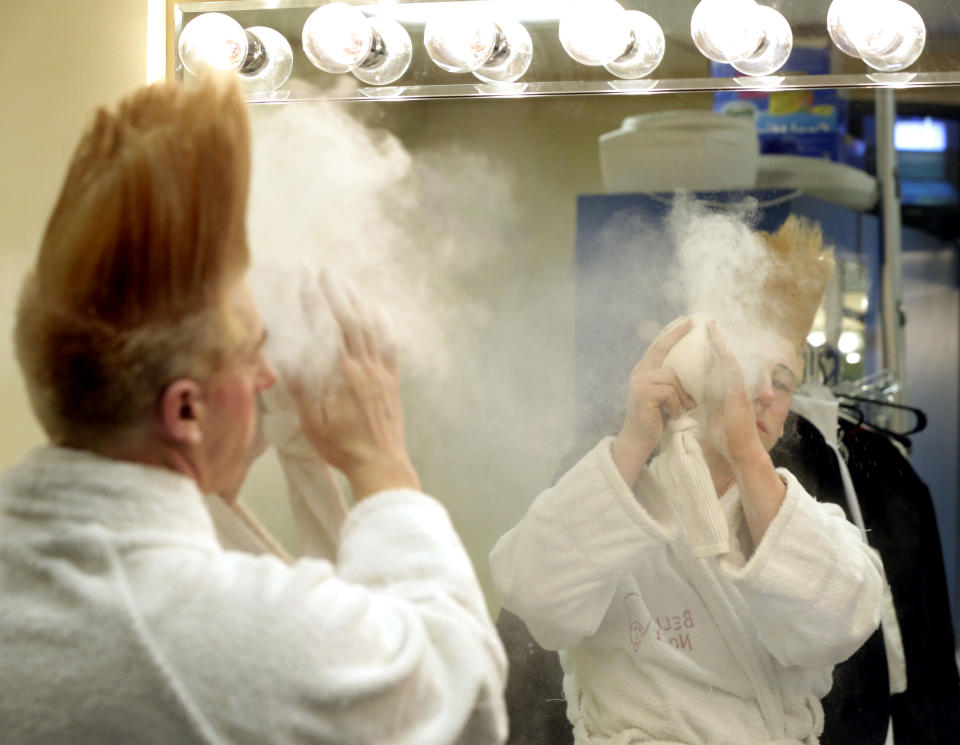 This March 23, 2013 photo shows performer Bello Nock appling make-up in his dressing room as he prepares for his "Bello Mania" show at the New Victory Theater in New York. Nock, a seventh-generation circus performer, is never offstage during the 90-minute performance, which combines slapstick clowning with death-defying aerial stunts. He performs through March 31 at the New Victory before moving on to the Canadian side of Niagara Falls and then a 10-week stint at the Beau Rivage Casino in Biloxi, Miss. (AP Photo/Richard Drew)