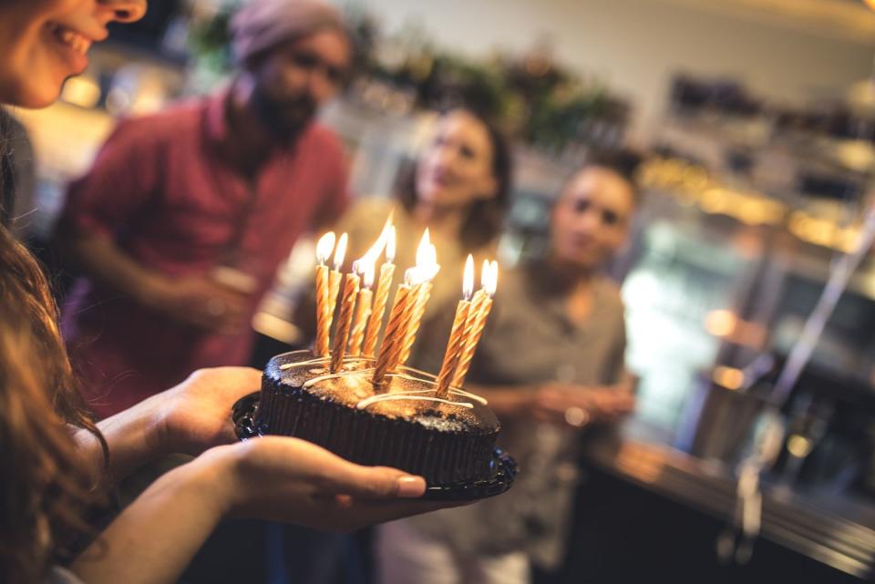 person carrying birthday cake