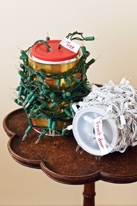 <p>You can also try winding unwieldy strings of lights around coffee cans. Cut an X in the plastic top, and stick the plug through. Label each string with masking tape and a marker to remind you which lights go on the tree and which go around the door.</p>