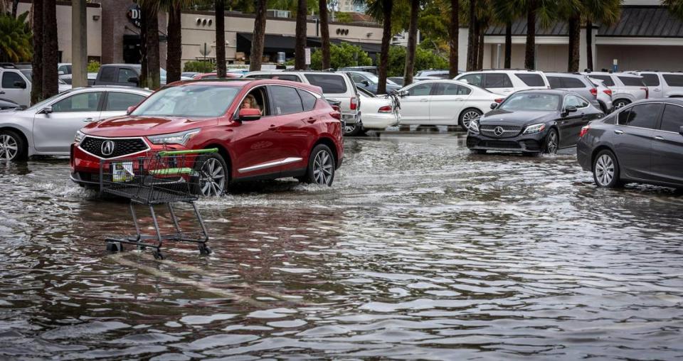 Vehicles move through a flooded parking lot at Town Center in Aventura on April 24, 2023. Heavy rainstorms and flooding are expected in the Miami and Fort Lauderdale area Monday and Tuesday.