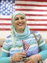 This September 2019 provided by Danielle Luna shows Iraqi born refugee Nada Al Rubaye at her naturalization ceremony in Phoenix. The artist left Baghdad after one of her sons and several other relatives were killed in the widespread violence. Al Rubaye and another son initially resettled in Turkey, but in 2013 came to Phoenix where they had family. Al Rubaye said she is excited to vote this fall in her first presidential election, saying it is "important for a person to feel like they belong to a country." (Danielle Luna via AP)