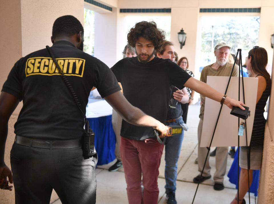 Aidan Jones, a second-year student studying philosophy and Classics at New College of Florida, is checked for weapons by security, before a meeting for students with new trustees Christopher Rufo and Jason "Eddie" Speir on Wednesday afternoon in Sarasota. New College officials said  someone sent a threatening email against Speir.