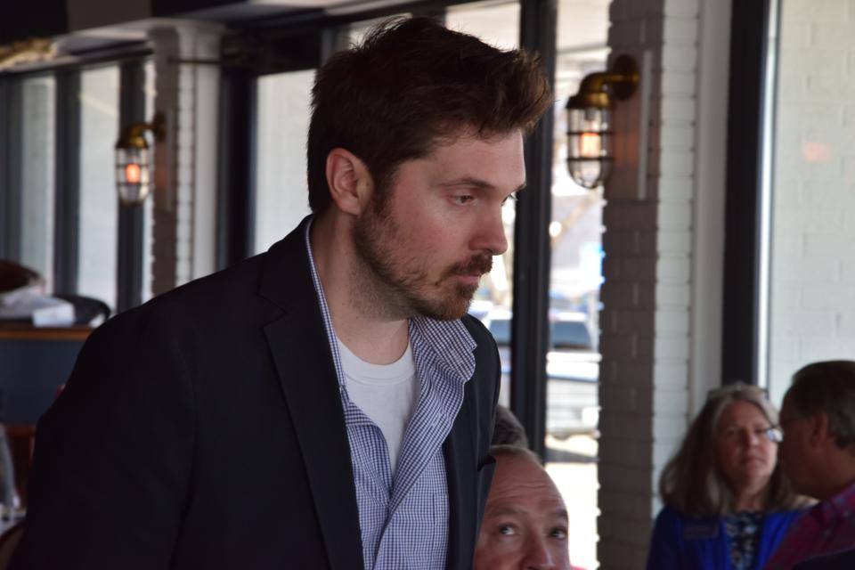 Harbor Springs City Manager Victor Sinadinoski walks to the front of the room during the city's State of the Community event.