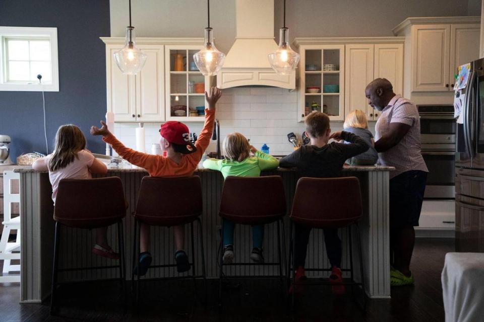 After playing outside, Peter Mutabazi serves his foster kids ice cream in their Charlotte home on Wednesday, June 5, 2023.
