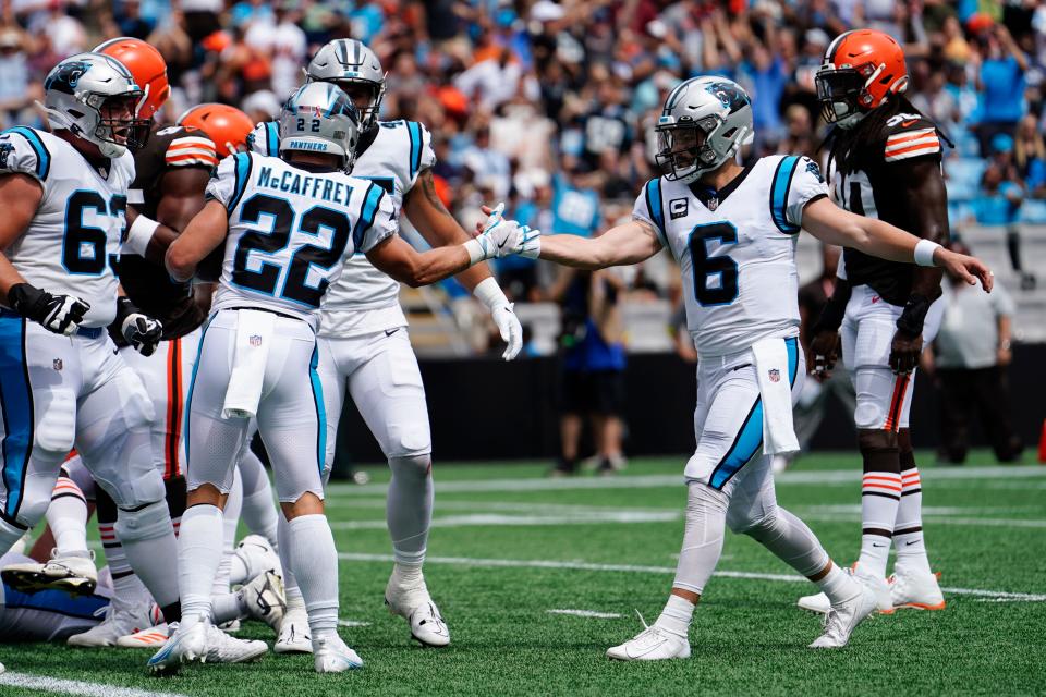 Carolina Panthers running back Christian McCaffrey celebrates after scoring with quarterback Baker Mayfield during the first half of an NFL football game against the Cleveland Browns on Sunday, Sept. 11, 2022, in Charlotte, N.C. (AP Photo/Jacob Kupferman)