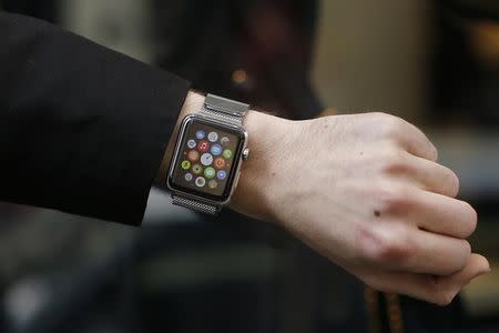 A customer presents his Apple Watch after buying it at a store in Paris, France, April 24, 2015. REUTERS/Benoit Tessier/Files