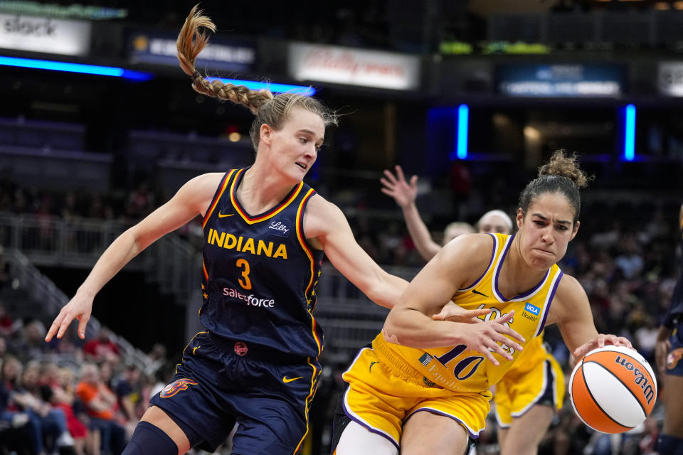 Los Angeles Sparks guard Kia Nurse (10) is fouled by Indiana Fever guard Kristy Wallace (3) during the second half of a WNBA basketball game in Indianapolis, Tuesday, May 28, 2024. (AP Photo/Michael Conroy)