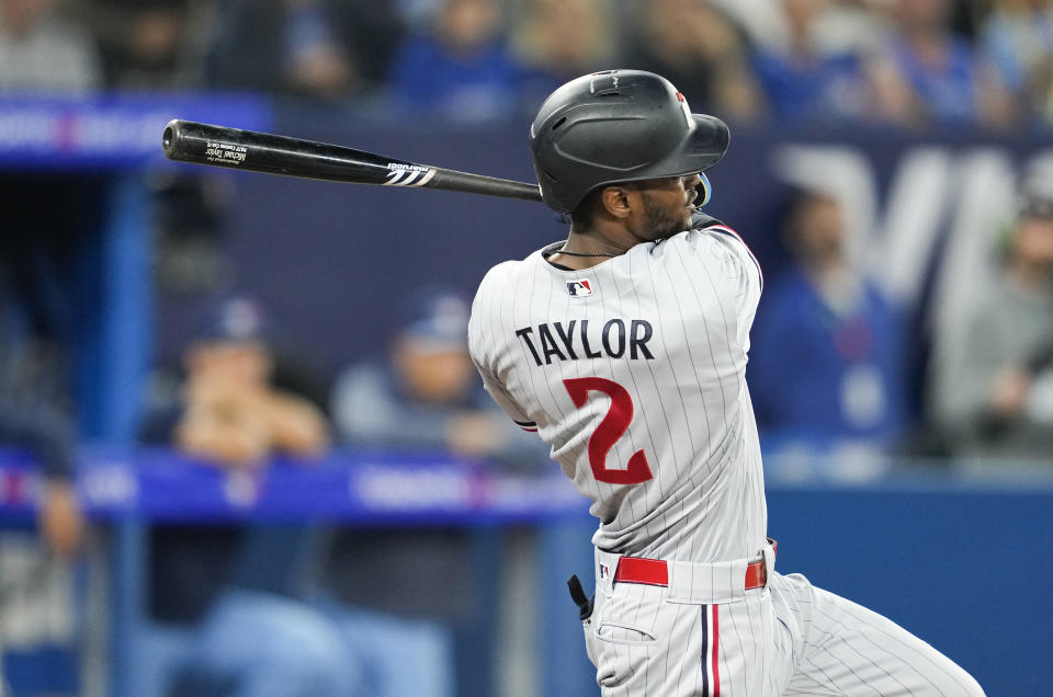 Minnesota Twins' Michael A. Taylor follows through an RBI sacrifice fly against the Toronto Blue Jays during the 10th inning of a baseball game Friday, June 9, 2023, in Toronto. (Mark Blinch/The Canadian Press via AP