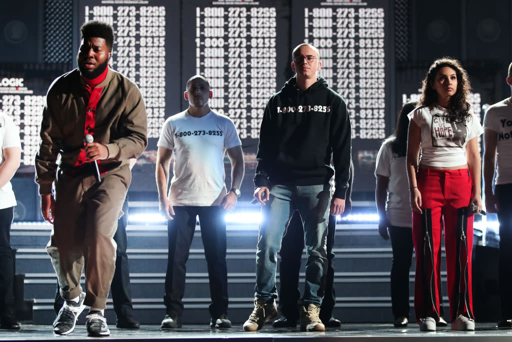 Logic, center, wore an important phone number on his black hoodie. (Photo: Getty Images)