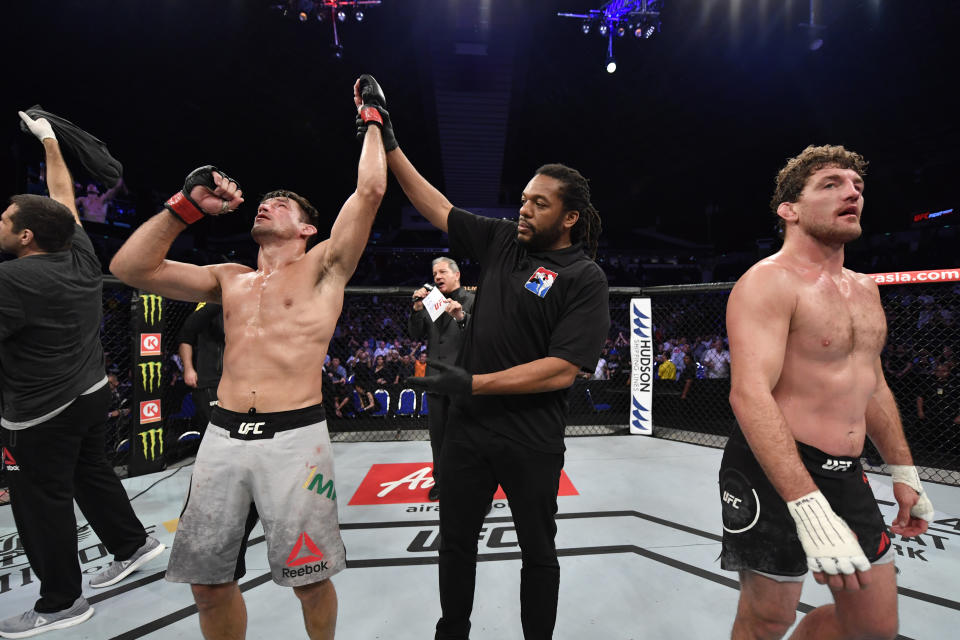 (L-R) Demian Maia celebrates his victory over Ben Askren in their welterweight bout during the UFC Fight Night event at Singapore Indoor Stadium on Oct. 26, 2019 in Singapore. (Getty Images)