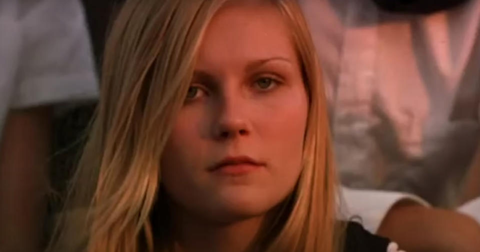 Kirsten Dunst looking ahead with a serious expression in a close-up shot in The Virgin Suicides