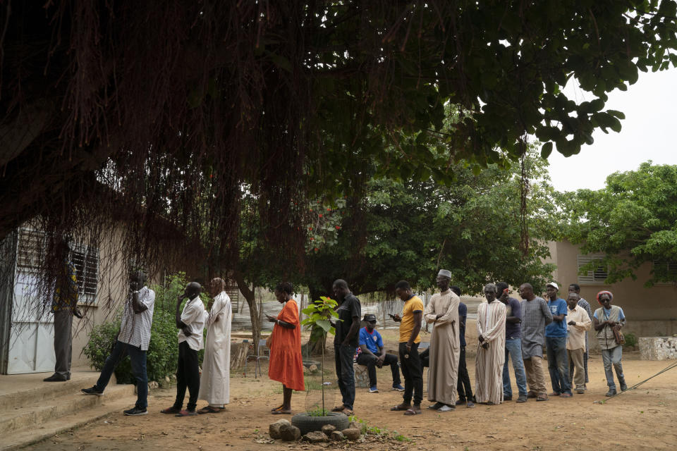 People line up to cast their ballot for legislative elections in Dakar, Senegal, Sunday, July 31, 2022. The West African nation is holding legislative elections, a vital test for opposition parties trying to minimize ruling party influence before 2024 presidential elections amid worries President Macky Sall may seek a third term. (AP Photo/Leo Correa)