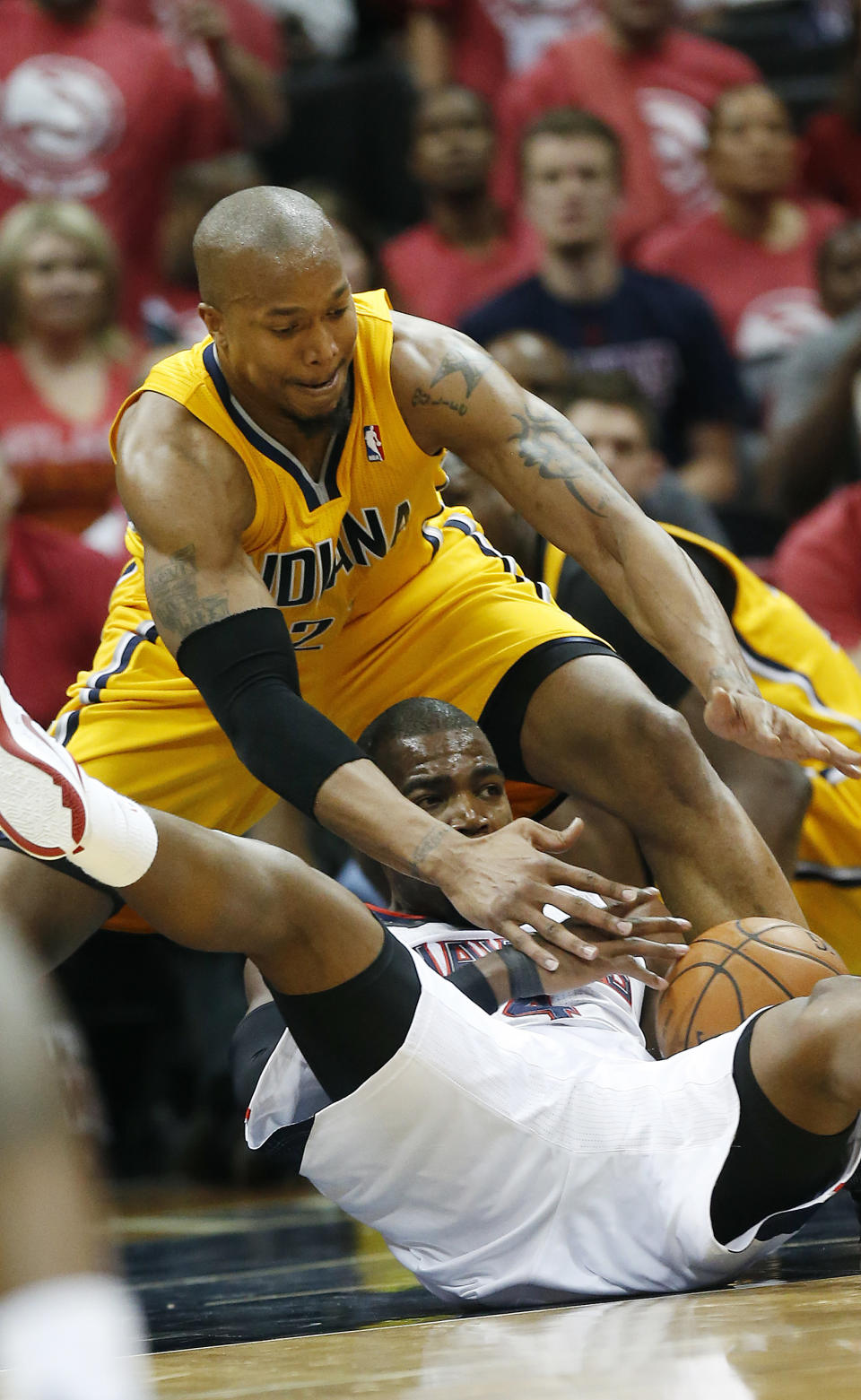 Atlanta Hawks forward Paul Millsap, bottom, and Indiana Pacers forward David West, top, battle for a loose ball in the first half of Game 6 of a first-round NBA basketball playoff series in Atlanta, Thursday, May 1, 2014. (AP Photo/John Bazemore)